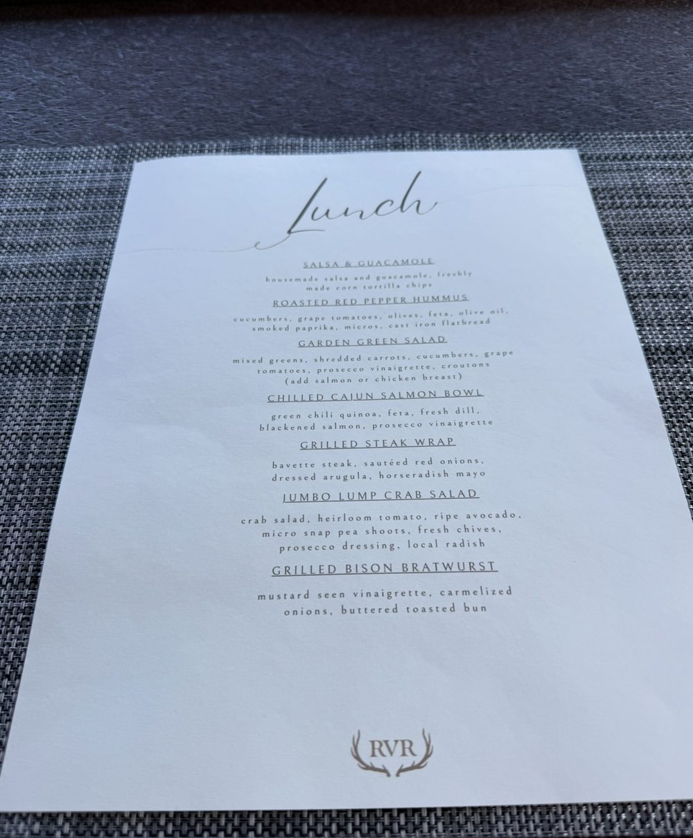Riverview Ranch lunch menu with salsa and guacamole, roasted red pepper hummus, garden green salad, chilled Cajun salmon bowl, grilled steak wrap, jumbo lump crab salad and grilled bison bratwurst