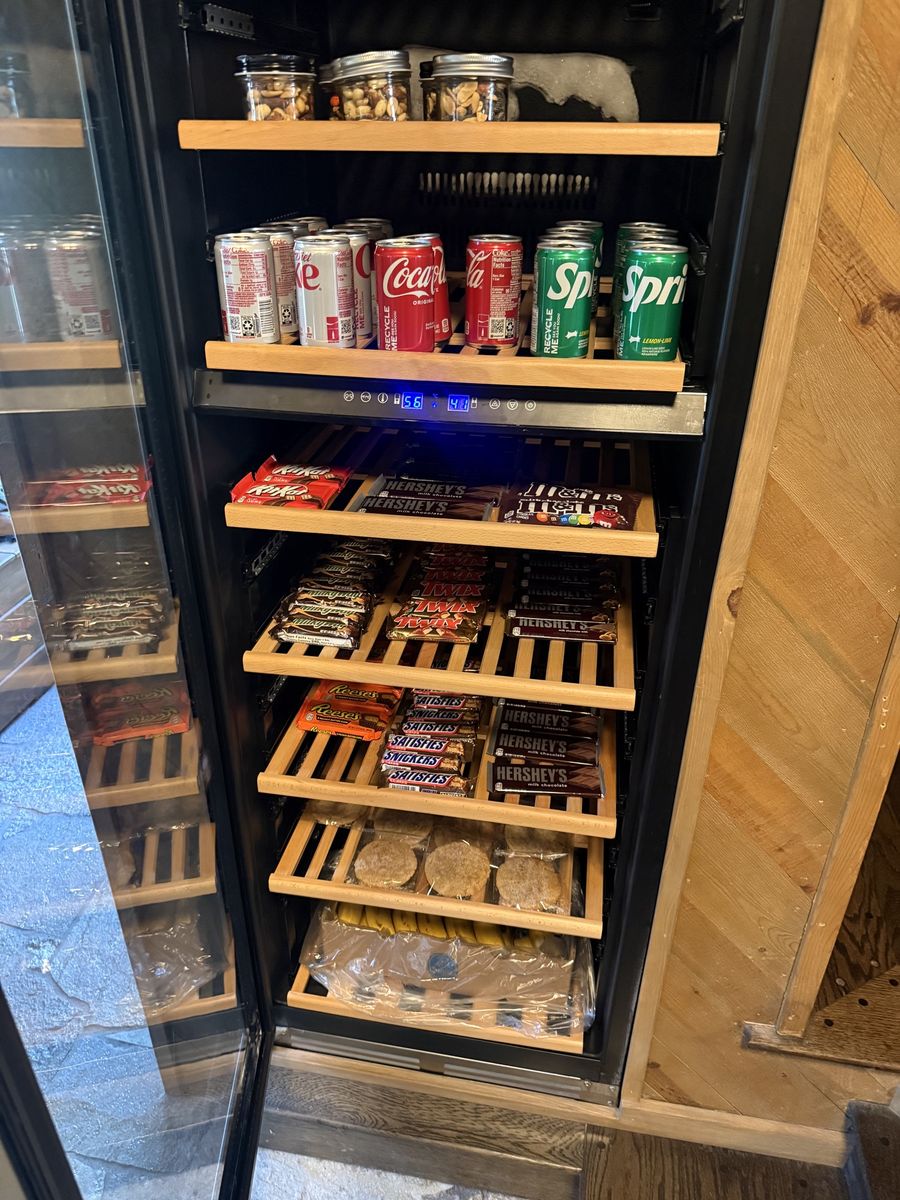 Lobby snack fridge stocked with drinks, candy and snacks